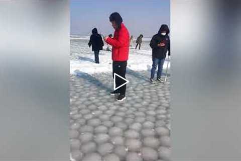 Huge Bubbles Of Ice Sit Underneath Frozen Lake