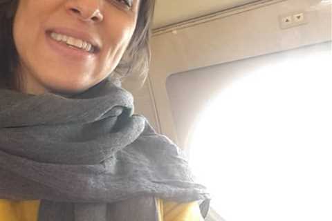 Nazanin Zaghari-Ratcliffe beams from safety of the skies as she heads home to Britain after six..