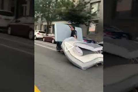 New Yorker drags two mattresses on a Motorcycle