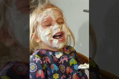 Two-year-old can''t contain her laughter as dad paints her face in yoghurt