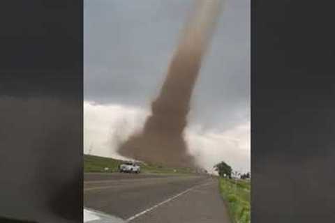 Incredible footage of a large tornado slowly crossing the road in Colorado, USA