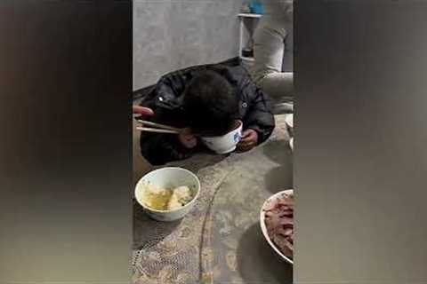 Tired toddler's face ends up in his bowl of noodles