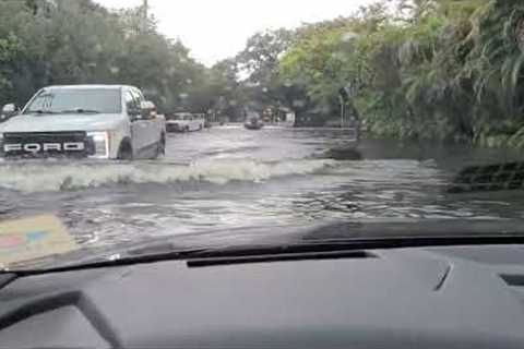 Cars and trucks stuck on flooded road as torrential rains hit Florida