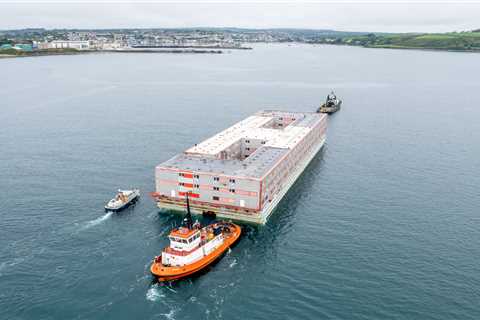 Huge three-storey barge that will house 500 migrants with a pool table and gym arrives in the UK