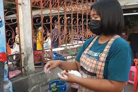 Food vendor rapidly flicks rice balls into pot like machine gun