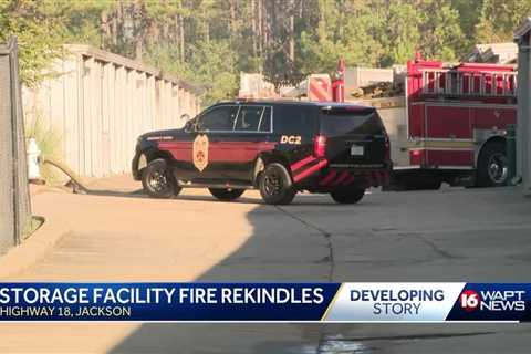 Fire at storage facility rekindles